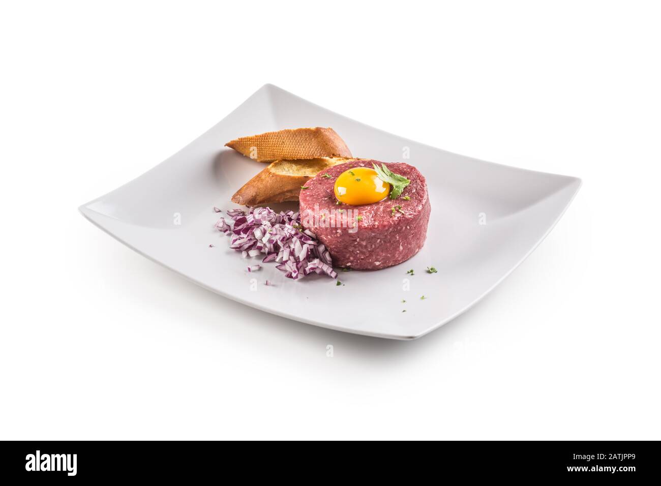 Tartare di manzo con tuorlo d'uovo erbe di cipolla rossa e bruschetta isolato su bianco Foto Stock