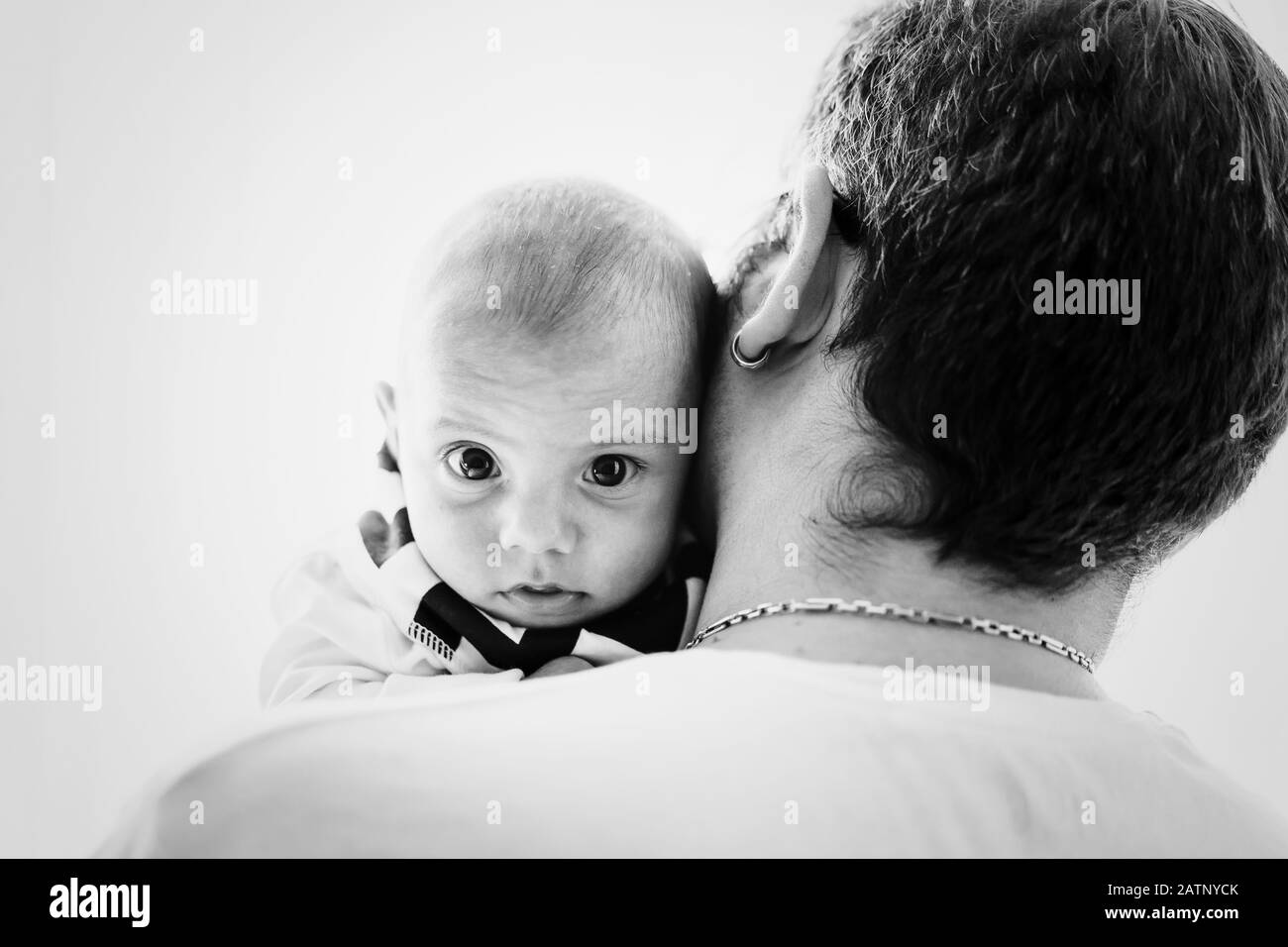 Ritratto di bambino carino su spalla padri e guardando alla fotocamera. Infanzia, paternità, concetto di famiglia. Foto Stock