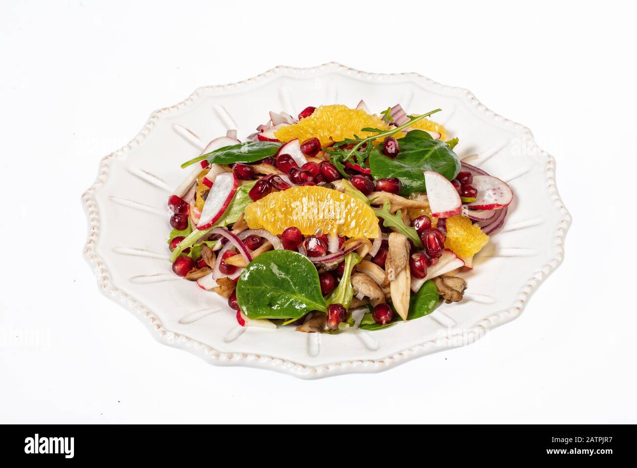 Insalata servita su un piatto di porcellana con fette di arancia, melograno, rucola e ostriche funghi, sfondo bianco, cibo, Russia Foto Stock