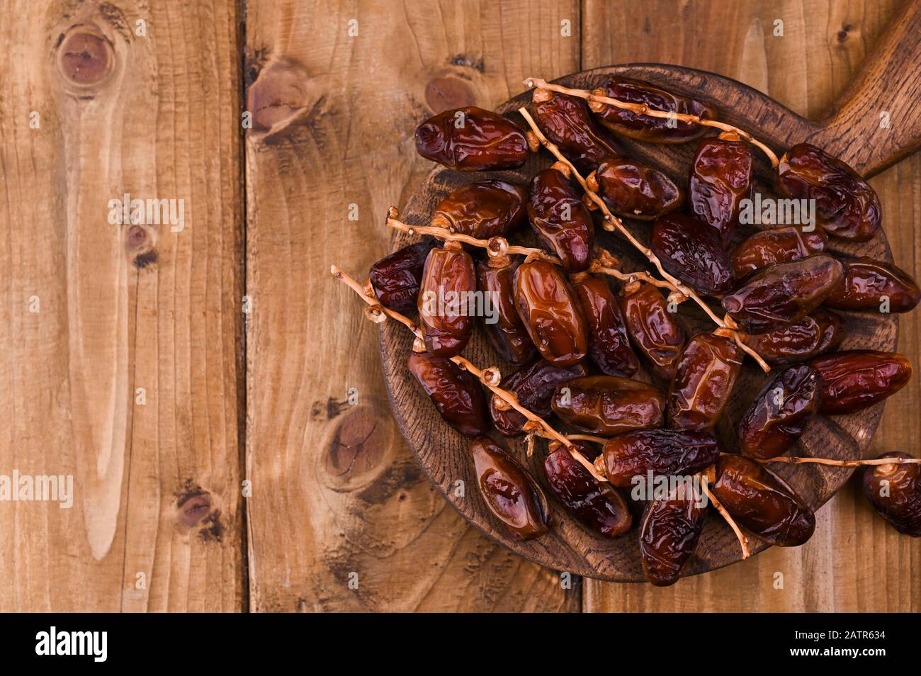 Crudo Biologico Medjool Date Pronto A Mangiare . Dolci orientali su sfondo di legno. Spazio di copia. Foto Stock