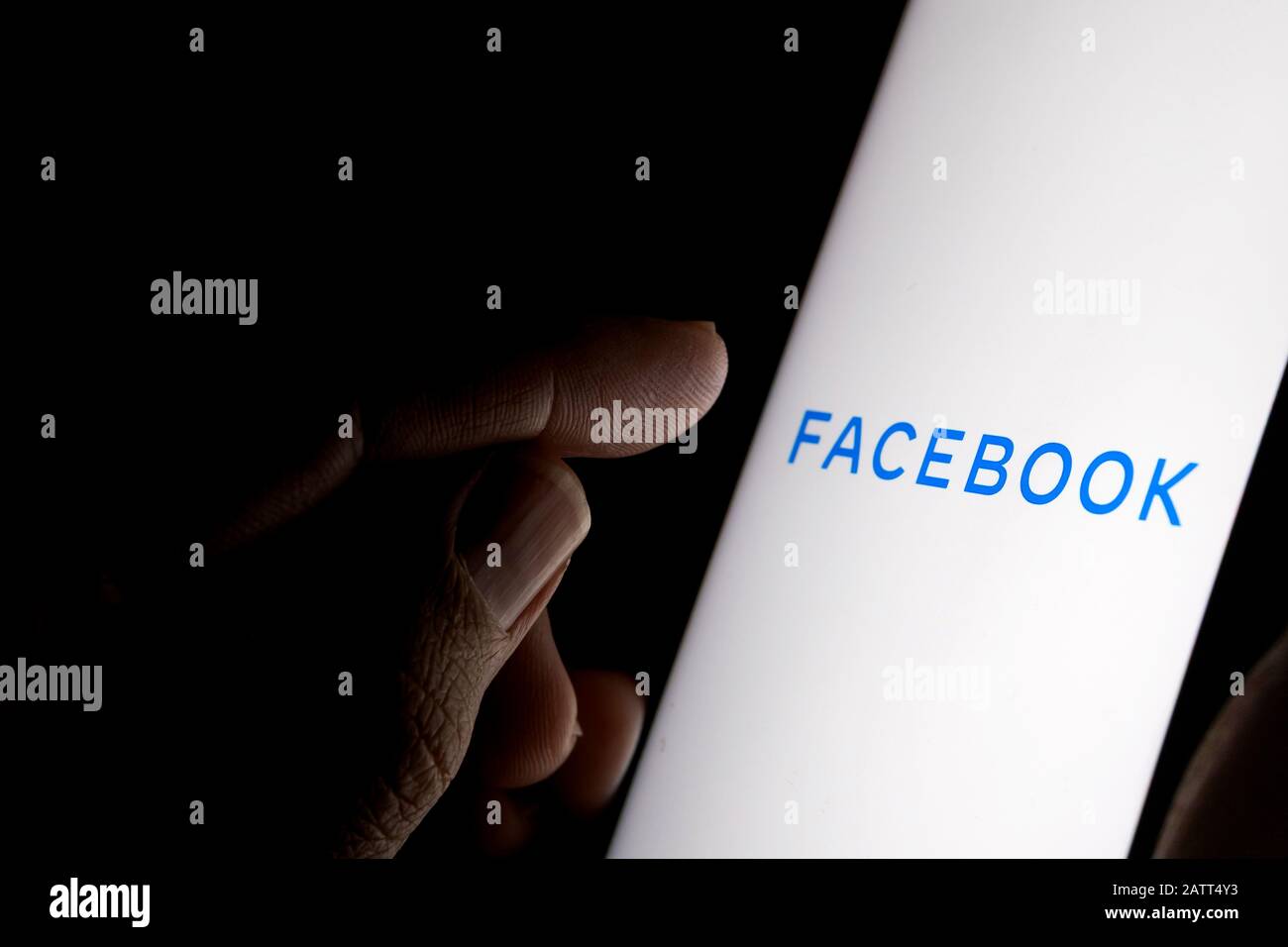 Nuovo logo aziendale di Facebook sullo schermo scuro e dito che punta ad esso. Foto concettuale. Foto Stock