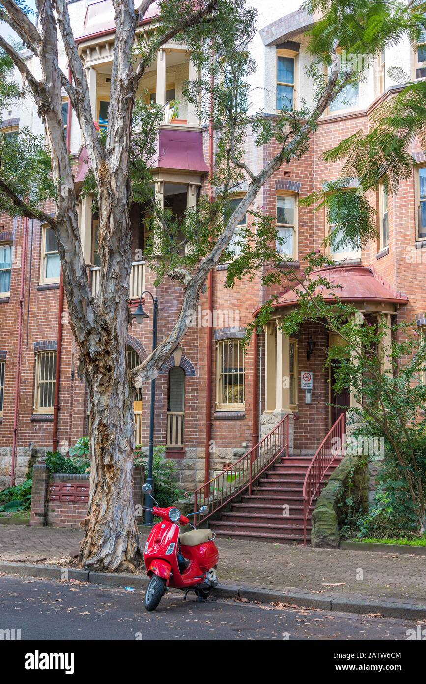 Sydney, Australia - 25 aprile 2016: Scooter rosso acceso e motorizzato parcheggiato di fronte all'edificio nel sobborgo interno di Sydney Foto Stock