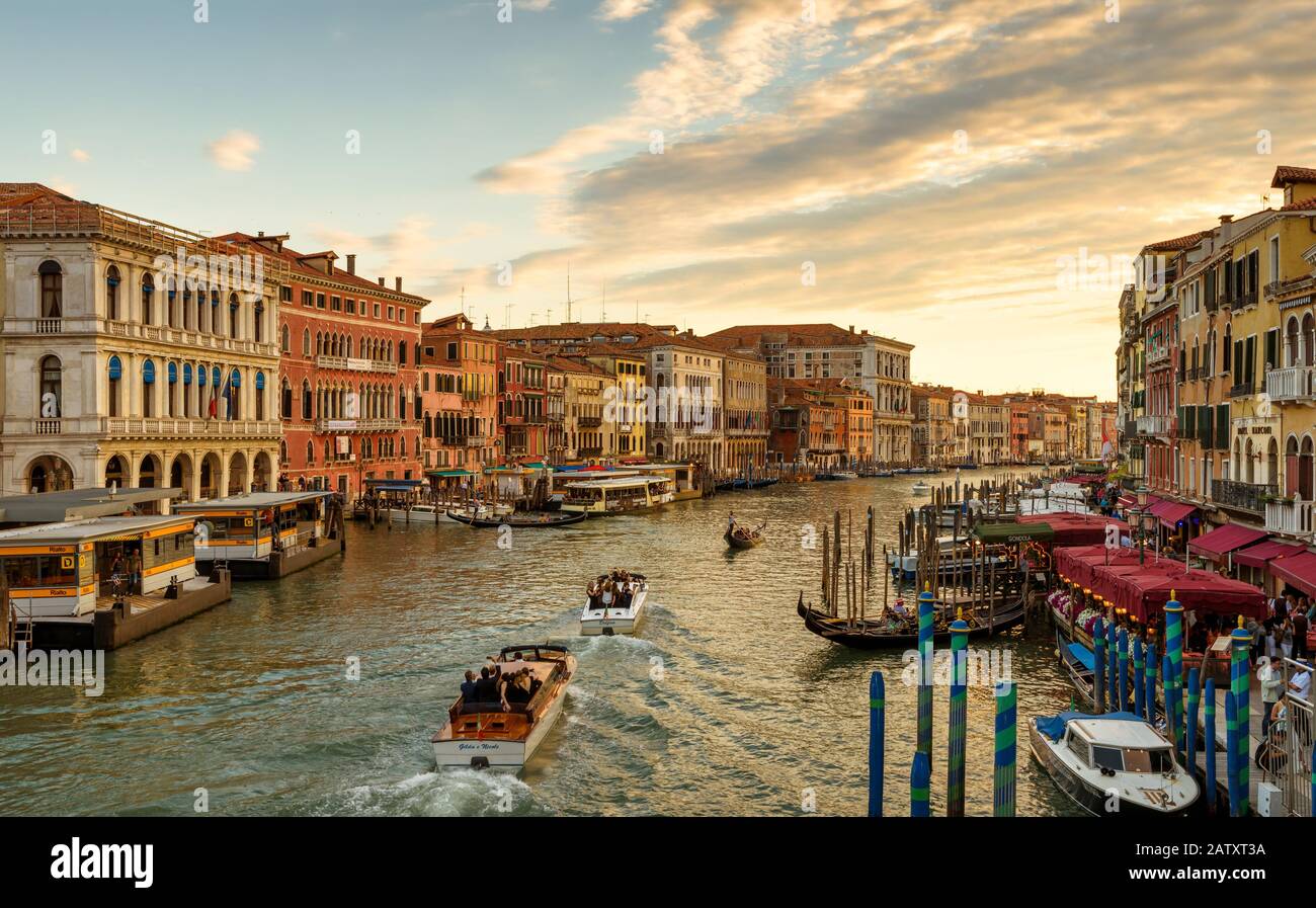 Venezia, Italia - 17 maggio 2017: Taxi d'acqua e gondole navigano lungo il Canal Grande al tramonto. Il Canal Grande è uno dei principali canali di traffico acquatico Foto Stock