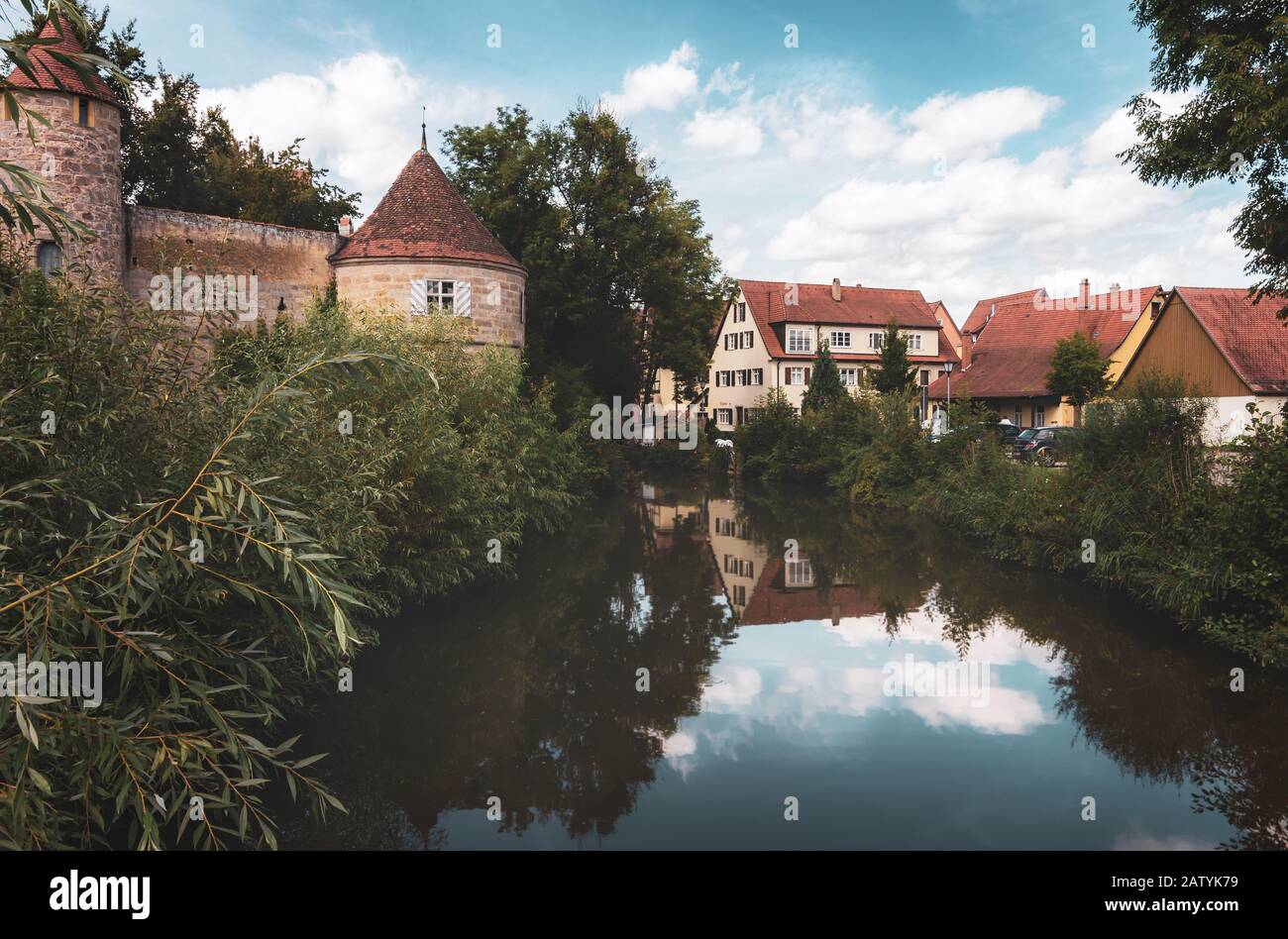 Vista sulle mura medievali intorno alla città di Dinkelsbuhl e la sua riflessione nel fiume Wornitz - Germania Foto Stock
