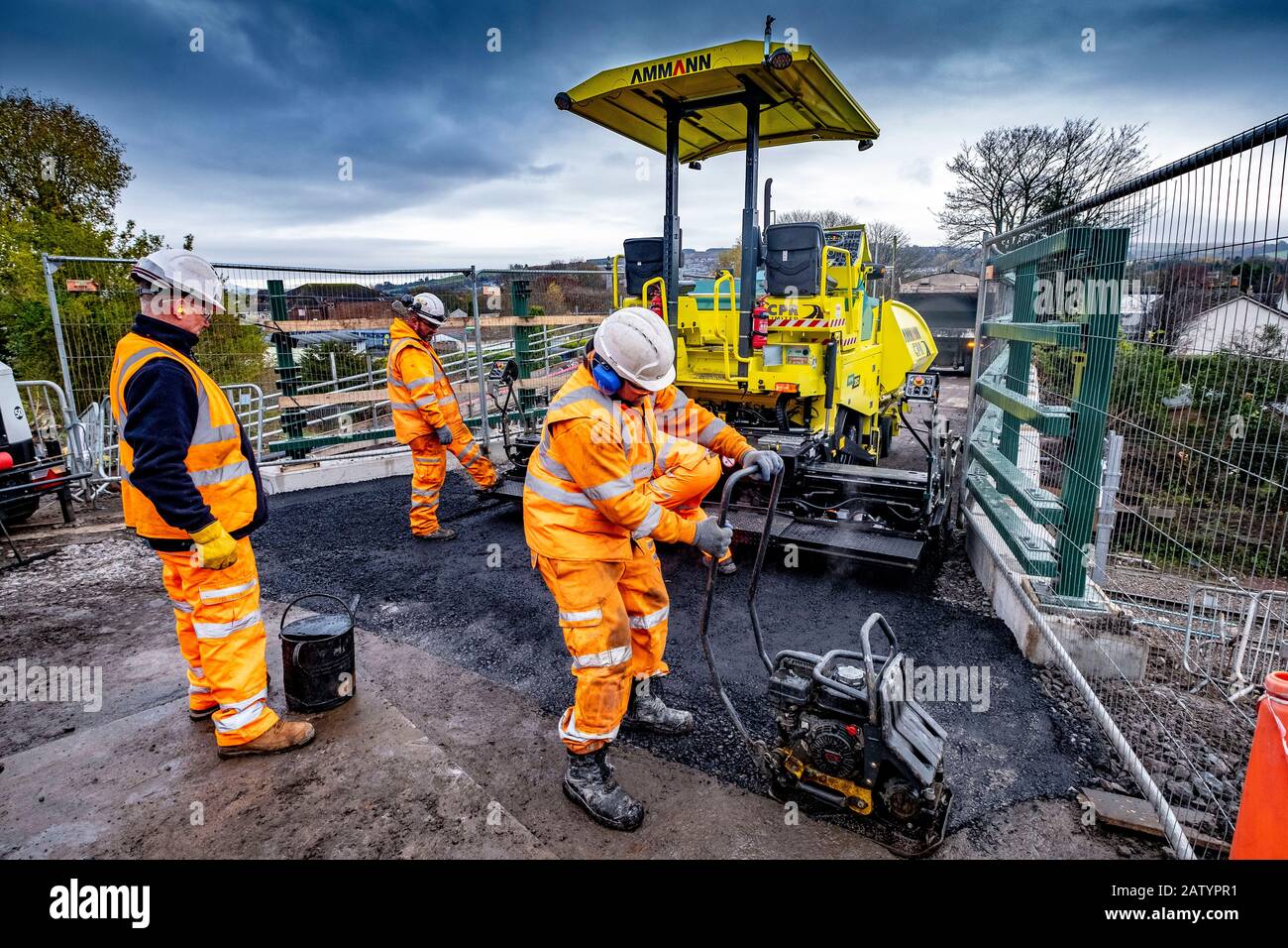 Posa di una nuova strada su un ponte ferroviario Foto Stock