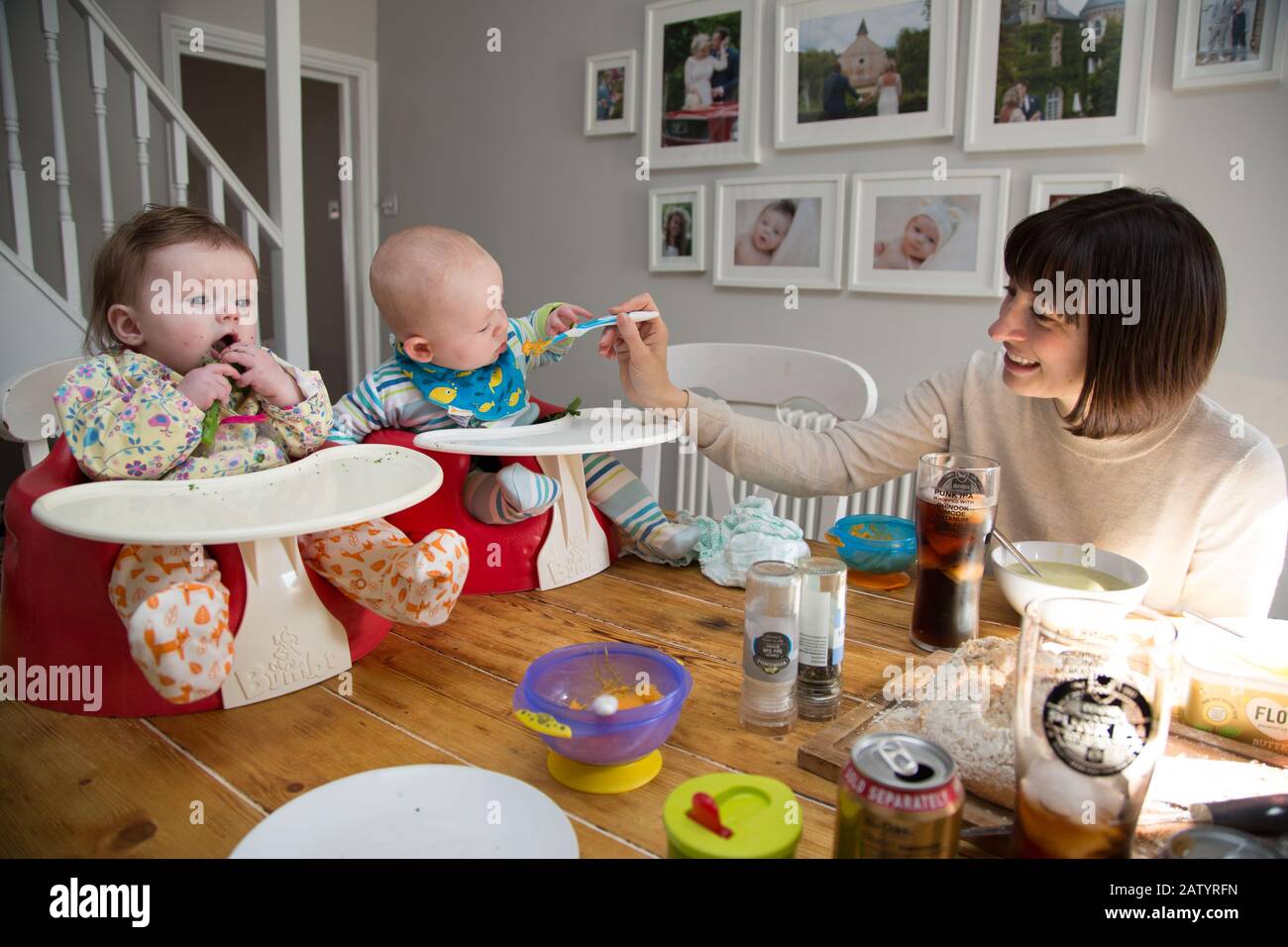 gemelle di 6 mesi in bumbo che vengono svezzate Foto Stock