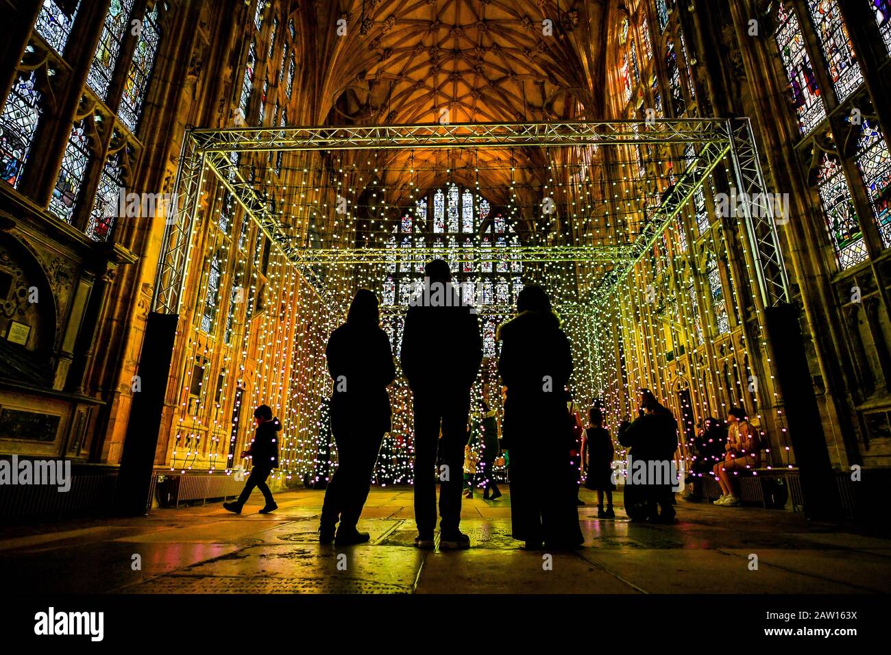 La gente guarda 'Dove c'è la luce' opere d'arte installate nella Lady Chapel presso la Cattedrale di Gloucester, che consiste di centinaia di luci individuali che mimano i colori di un arcobaleno, durante una narrazione e musica, progettato da un gruppo di arti digitali, Squidminestra. Foto Stock