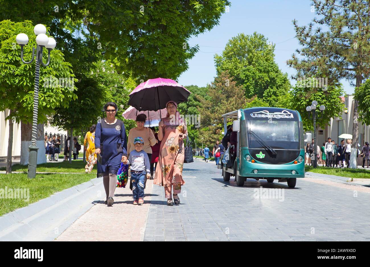 Walker con ombrellone e golf card in via Tashkent, zona pedonale, Samarcanda, provincia di Samarqand, Uzbekistan Foto Stock