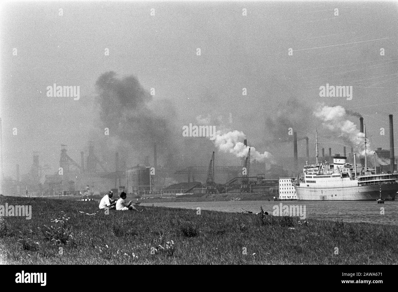 Inquinamento atmosferico a Hoogovens nel Mare del Nord; in primo piano persone sullo sfondo fumando Hoogovens Data: 3 agosto 1970 posizione: Mare del Nord Parole Chiave: Hoogovens, Associazione Di Inquinamento atmosferico Foto Stock