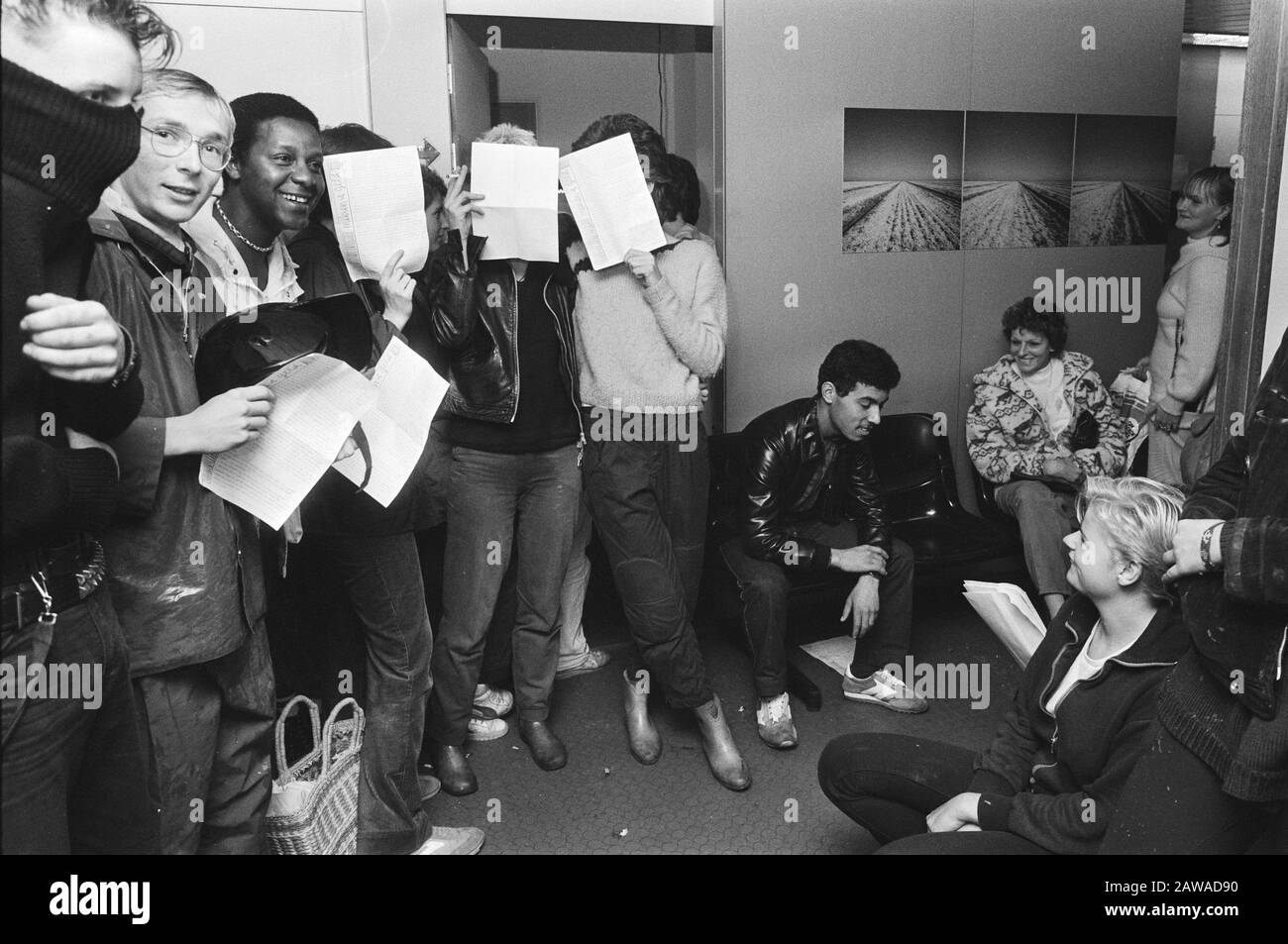 I membri del Meidenhuis occupano l'ufficio dei servizi sociali ad Amsterdam in relazione ai pagamenti sotto 18 ragazze che tengono carta per il viso durante l'occupazione Data: 7 ottobre 1982 luogo Amsterdam, Noord-Holland Parole Chiave: Occupazioni, case runiche Foto Stock