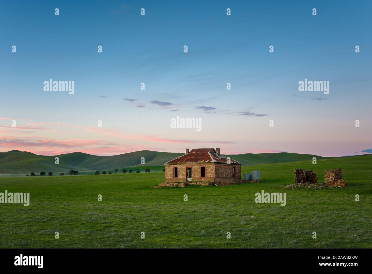 Un paesaggio panoramico delle rovine patrimonio storico di una casa di Cobb & Co, nell'ora d'oro di illuminazione del tramonto vicino a Burra in Australia del Sud. Foto Stock