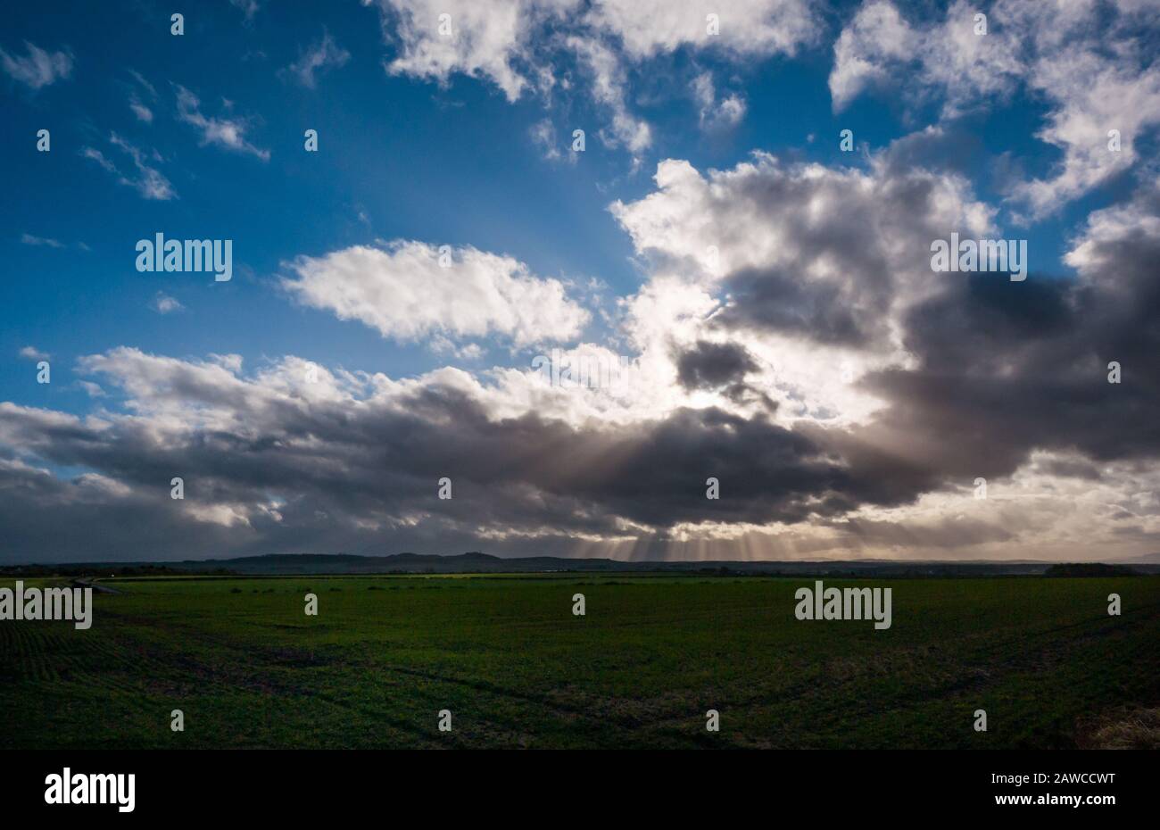 East Lothian, Scozia, Regno Unito. 8 Feb 2020. UK Weather: Un giorno luminoso e soleggiato ma molto ventoso come un fronte meteo annuncia l'arrivo di Storm Ciara. Una vista attraverso i campi con le formazioni di nuvole nel cielo Foto Stock