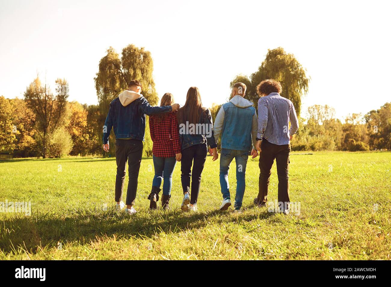I giovani camminano attraverso il prato parco in primavera. Foto Stock