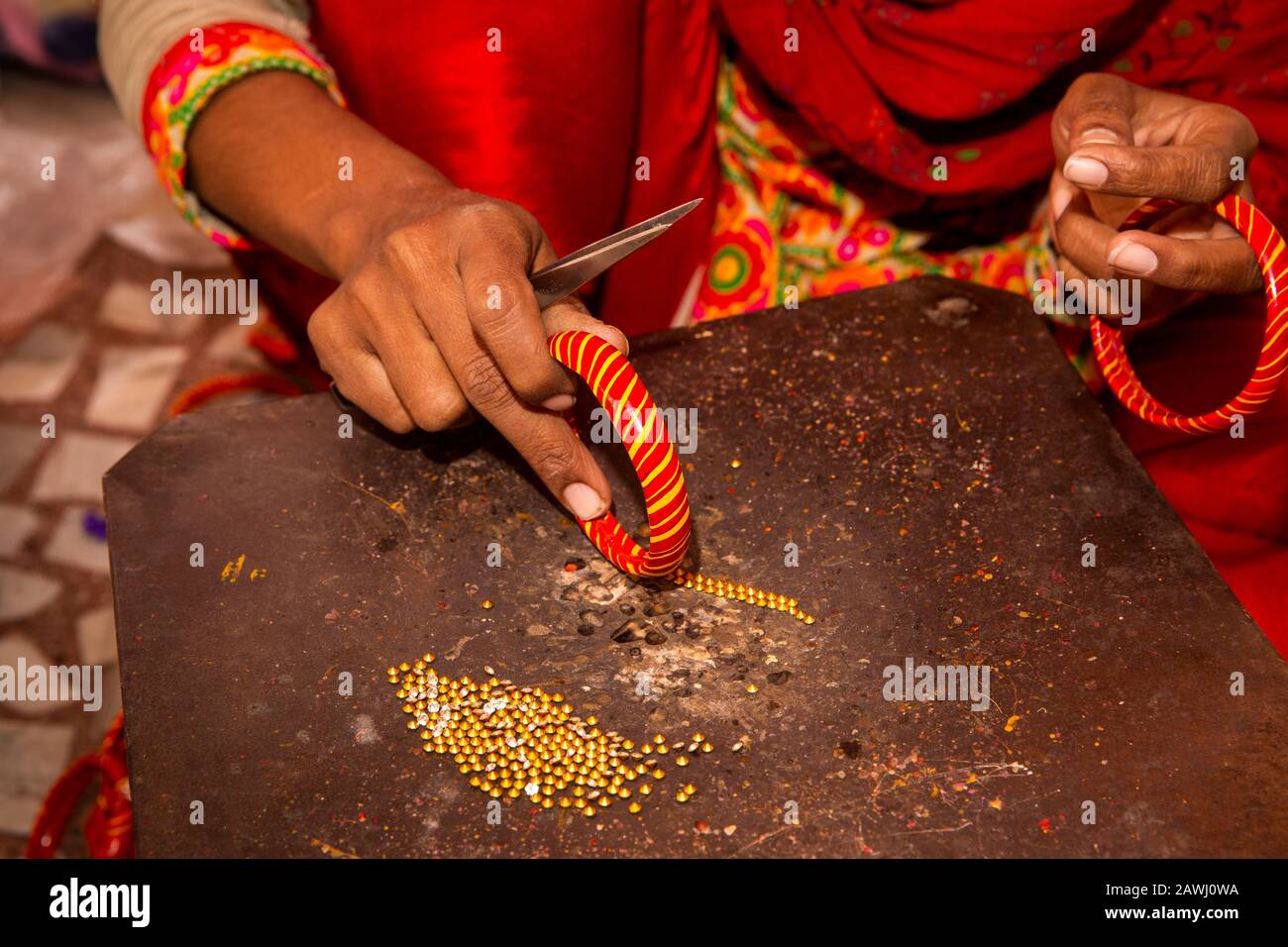 N10598 India, Rajasthan, Shekhawati, Nawalgarh, rendendo tradizionali Lac bangles a mano, premendo poco costoso gioiello decorazione in caldo angolo Foto Stock