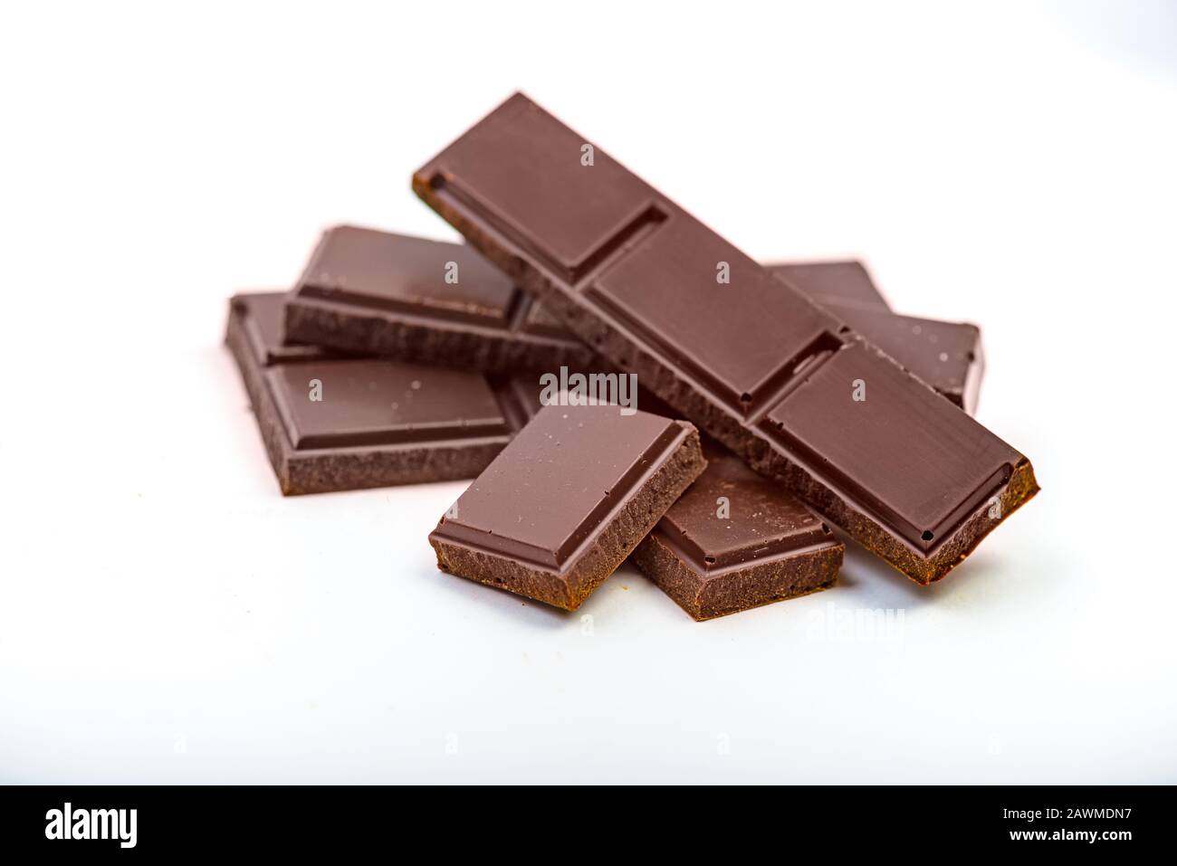 Pezzi di barretta di cioccolato fondente isolati su sfondo bianco Foto Stock