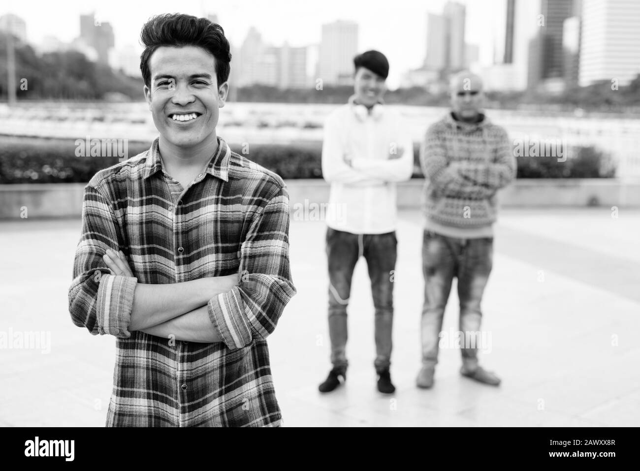 Tre giovani uomini asiatici di relax presso il parco insieme Foto Stock