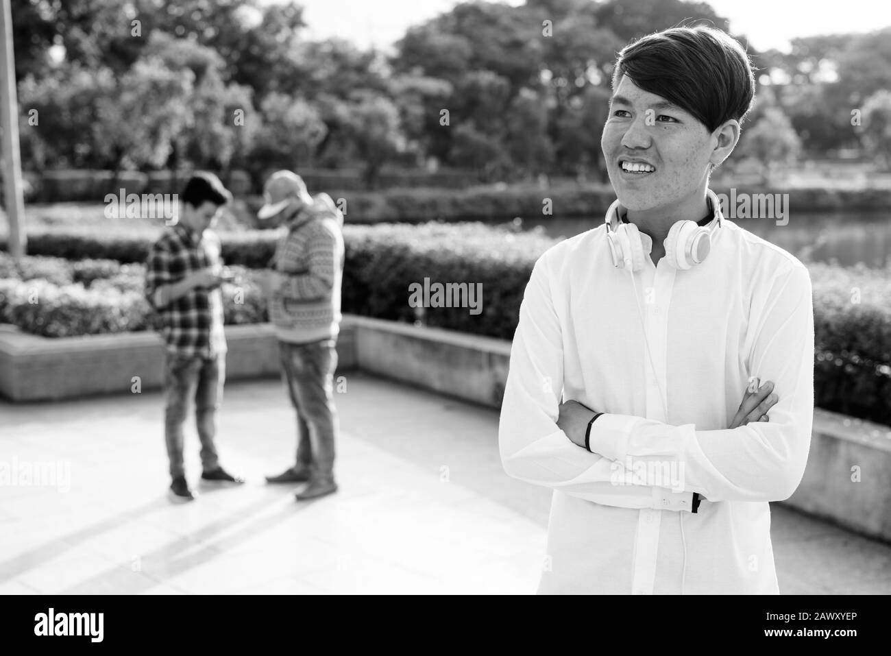Tre giovani uomini asiatici di relax presso il parco insieme Foto Stock