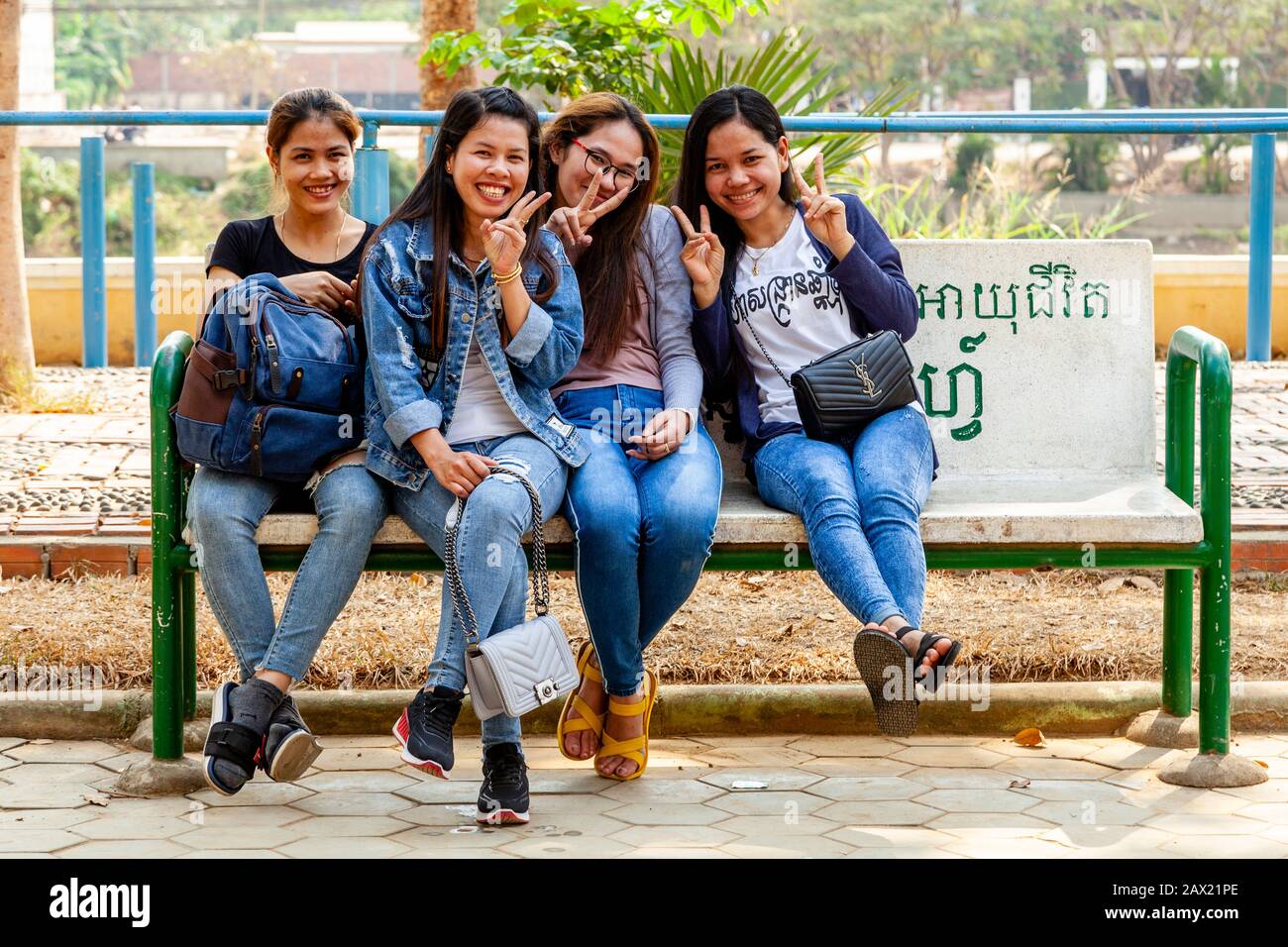 Un Gruppo Di Giovani Donne Cambogiane Seduti Su Una Panchina, Battambang, Cambogia. Foto Stock