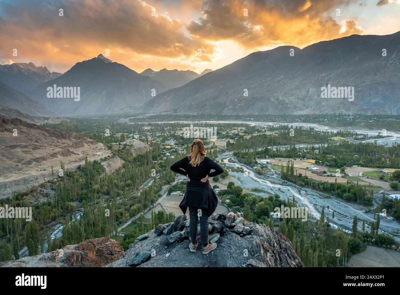 Viaggiatore femminile che guarda il tramonto nella Valle di Yasin, Pakistan settentrionale Foto Stock
