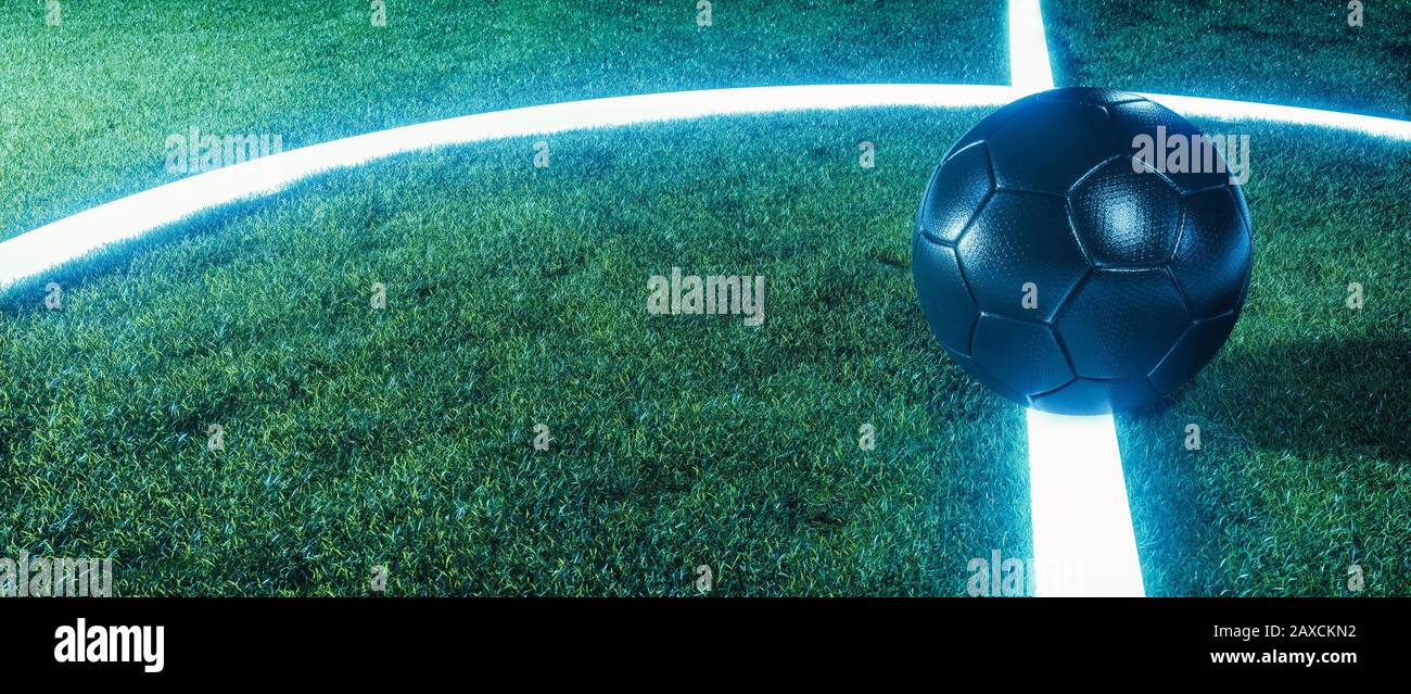 Campo da calcio neon con palla su linee incandescenti su un campo verde erboso di notte in un panorama banner con spazio copia per lo sport o il tema del calcio Foto Stock