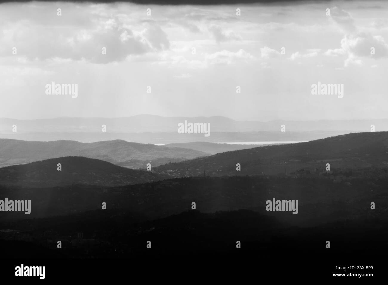 Una vista sulla città di Perugia (Umbria, Italia) al tramonto, al centro delle colline e nebbia, con il lago Trasimeno in lontananza Foto Stock