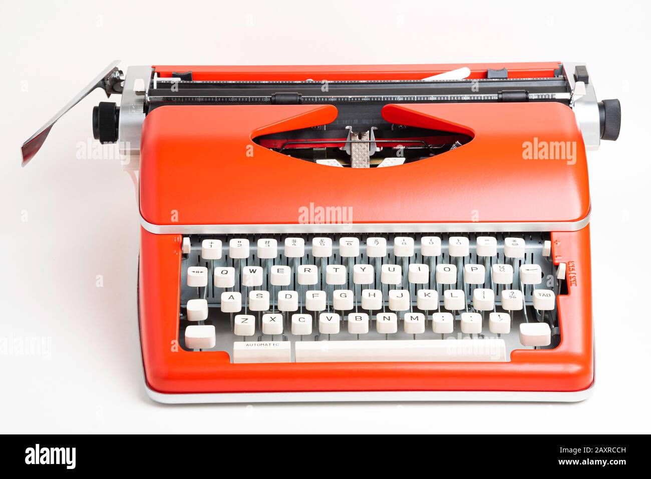 Un'immagine da studio di una macchina da scrivere manuale in stile retrò  con tastiera in plastica color avorio e rivestimento in metallo  rosso-arancione Foto stock - Alamy