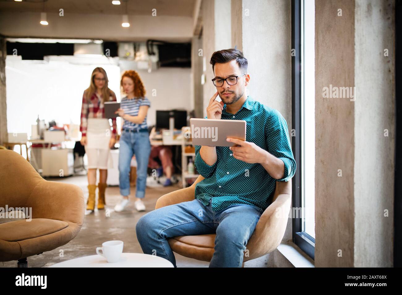 Giovane uomo utilizzando la tecnologia digitale compressa in corporate business office Foto Stock
