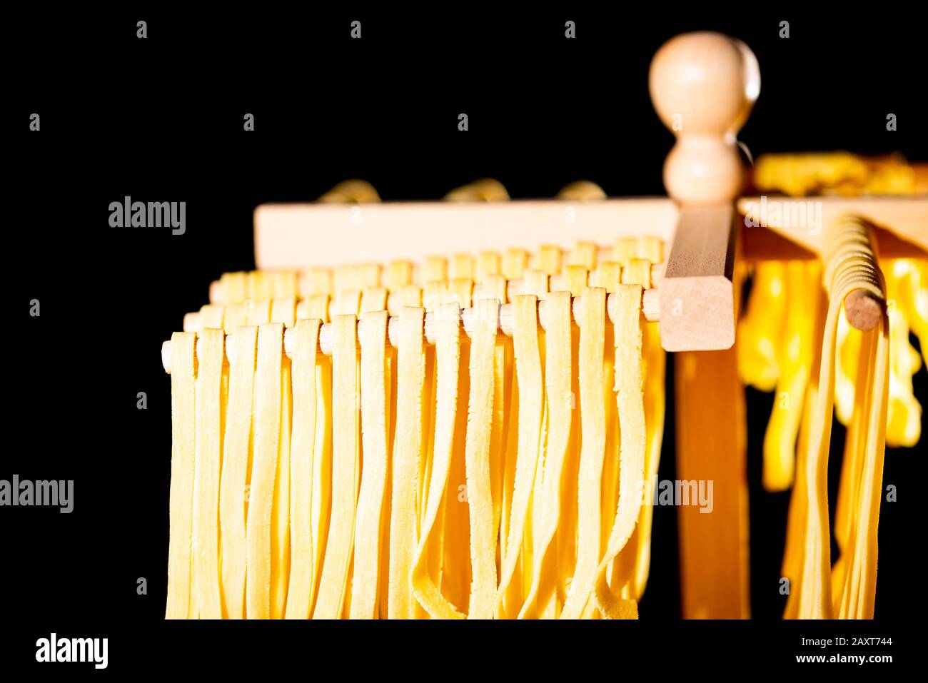 Tagliatelle pasta fatta in casa da pastificio asciugatura su bastoni di legno di supporto pasta Foto Stock