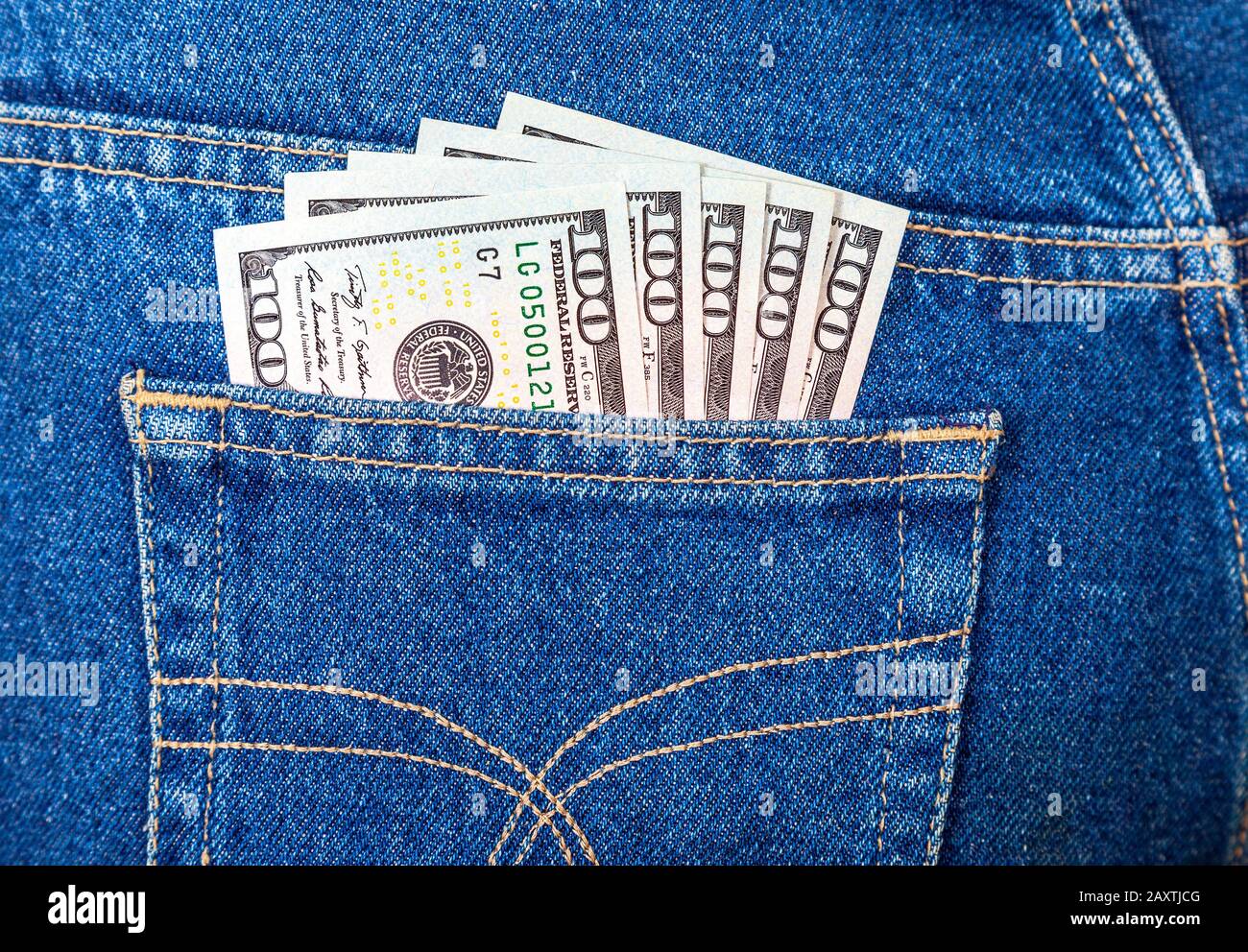 Banconote di cento dollari americani che si stacchino dalla tasca dei jeans Foto Stock