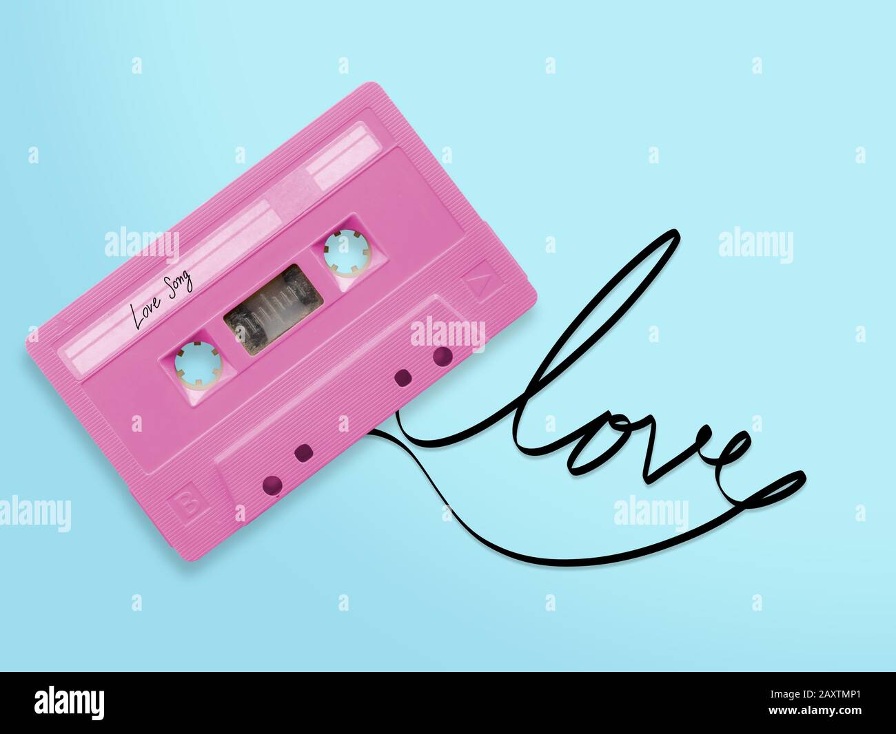 nastro per audiocassette rosa con etichetta tag amore canzone aggrovigliata nastro parola amore isolato su sfondo blu, vista dall'alto. Foto Stock