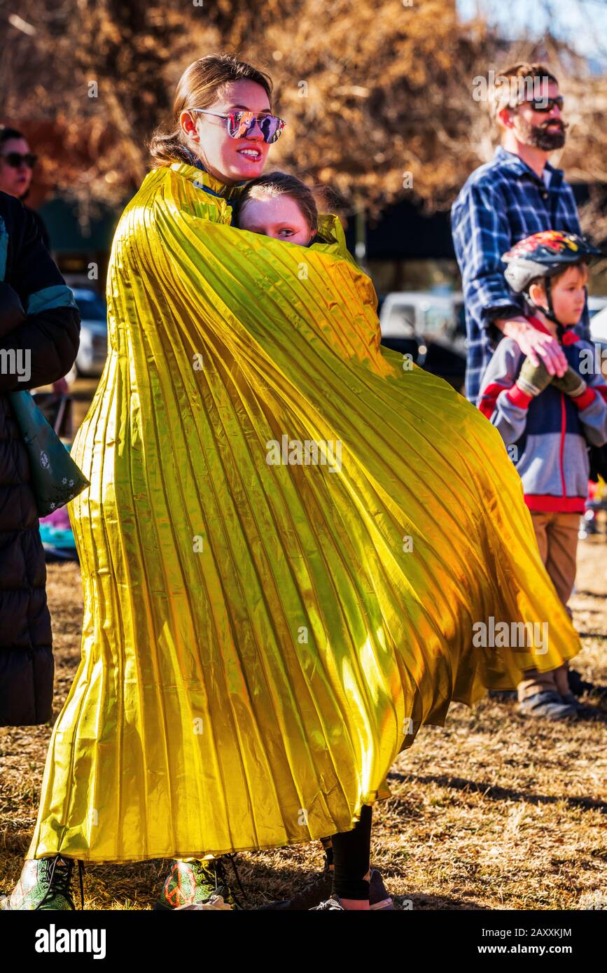 Spettatori avvolti in tessuto dorato; spettacolo Asiatico di Capodanno a Salida; Colorado; dal Colorado Asian Cultural Heritage Center di Denver; colore Foto Stock