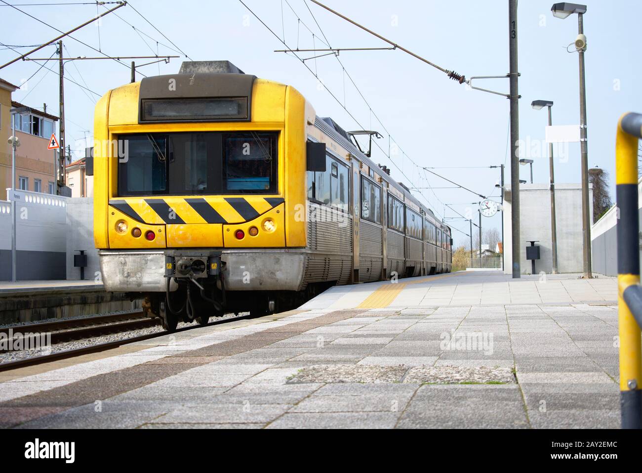 Treno giallo e argento in una stazione ferroviaria pronta per partire Foto Stock