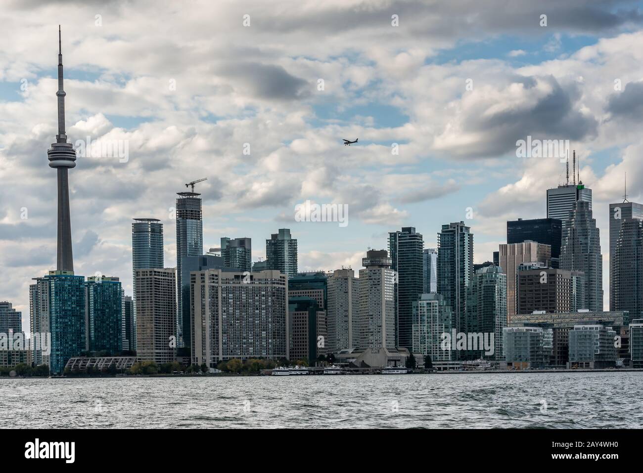 Un piccolo aereo vola sopra i grattacieli della vecchia Toronto Foto Stock