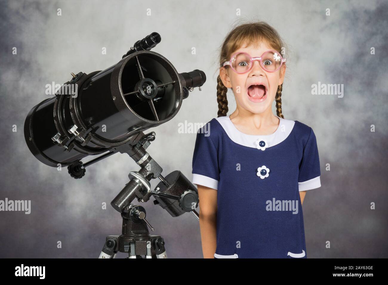 Ragazza astronomo felicemente sorpreso da ciò che egli vedeva nel telescopio Foto Stock