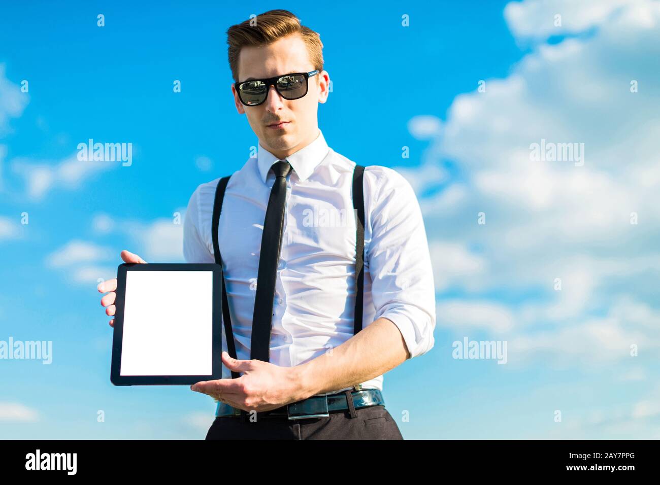 Giovane uomo d'affari in camicia bianca, cravatta, bretelle e occhiali da sole sho Foto Stock