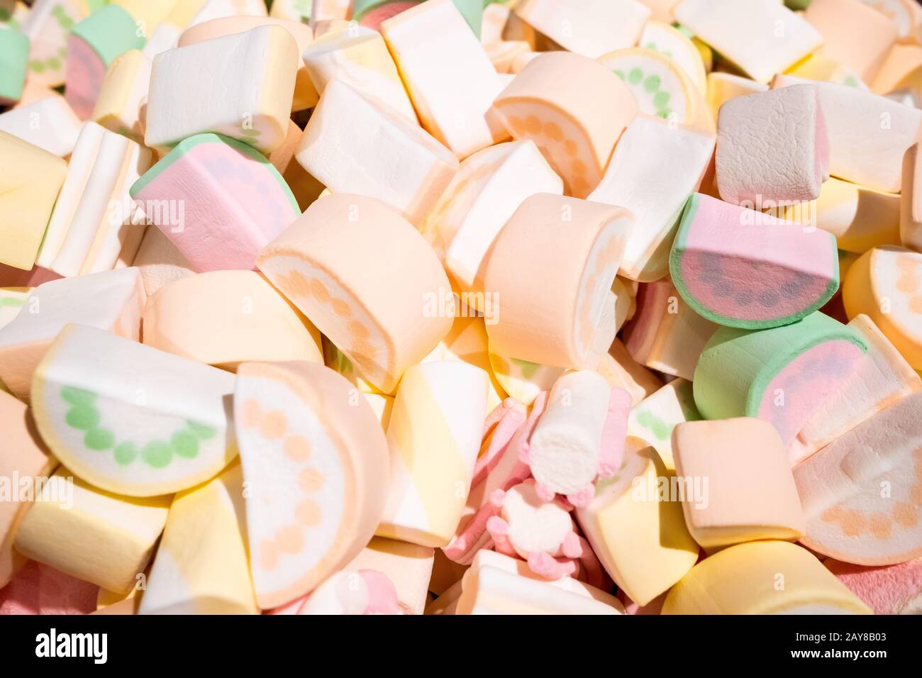 Un grande mucchio di marshmallows di aria dolce in un supermercato. Marshmallow sotto forma di fette di anguria verde, rosa, arancio e bianco. Dolce colorato Foto Stock