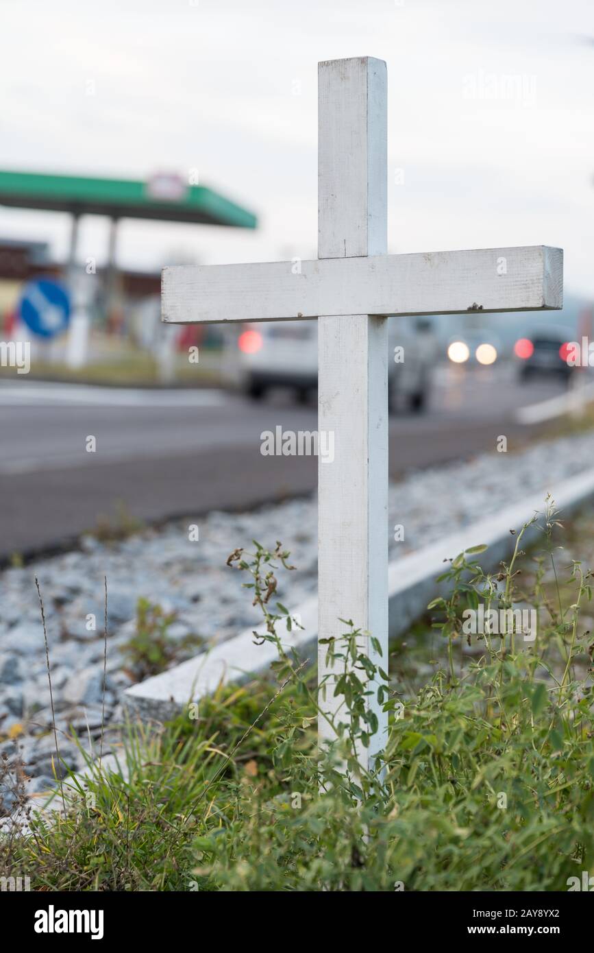 Cartello segnaletico con croce bianca sul lato della strada - incidenti mortali Foto Stock