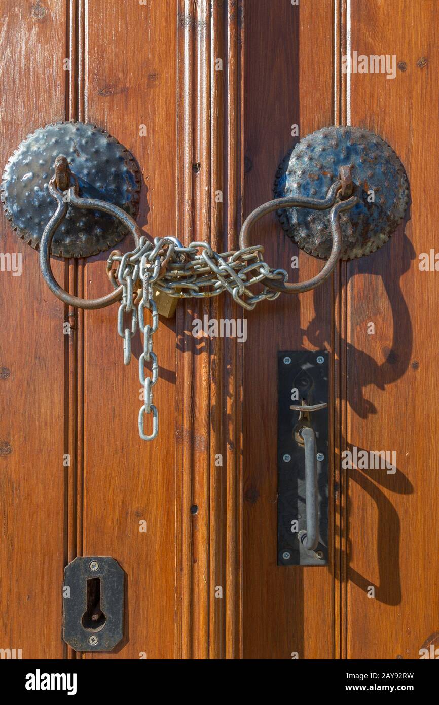 Vecchie maniglie di legno marrone della porta, catena e serratura Foto Stock