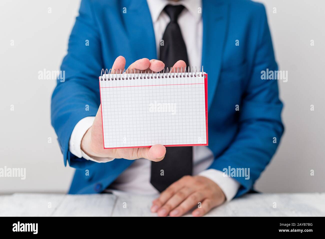 L'uomo tiene carta vuota con spazio per le copie davanti a lui. Concetto di business con l'uomo in una suite e una cravatta. Spazio bianco per pubblicità Foto Stock