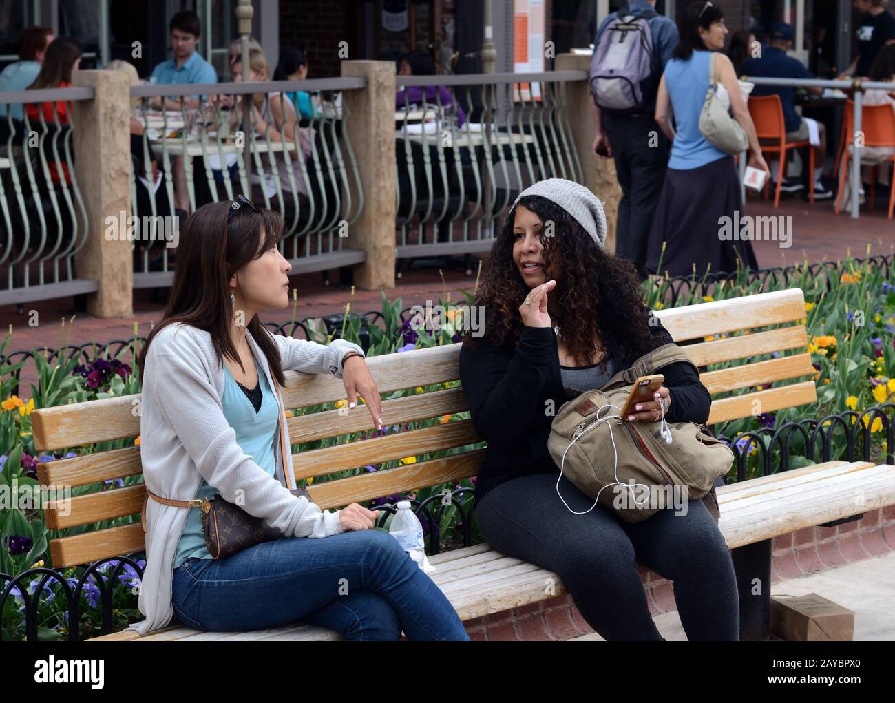 Due donne fanno una pausa al Pearl Street Mall, Boulder, Colorado. Ristoranti sullo sfondo. Foto Stock