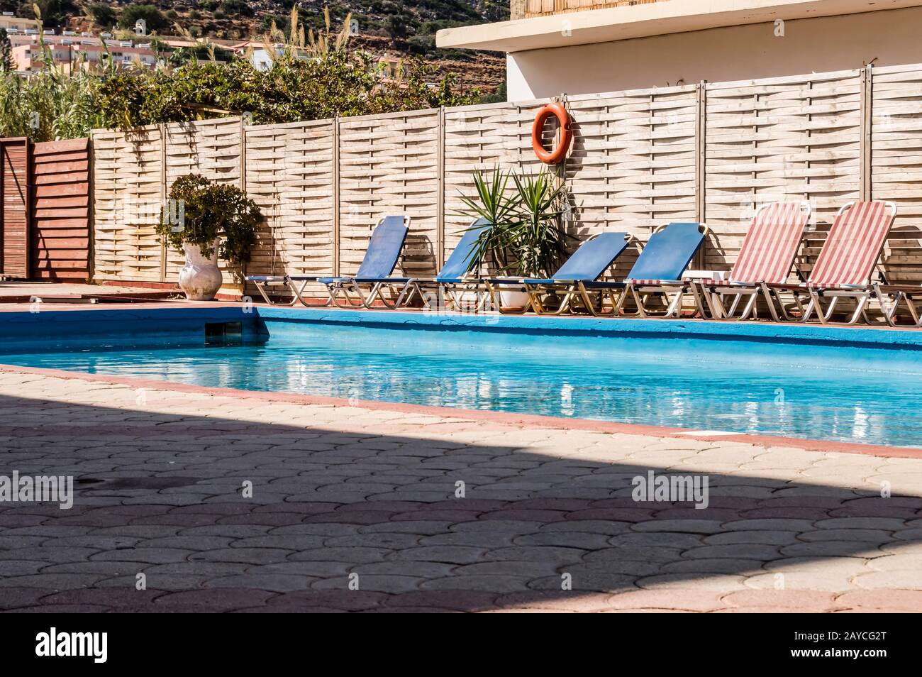 Piccola piscina rettangolare con lettini in un hotel Foto Stock