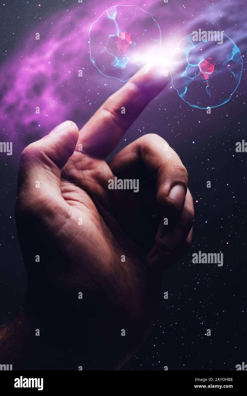 L'indice umano tocca la divisione cellulare. Polvere nebulosa in spazio infinito. Supporti misti. Foto Stock