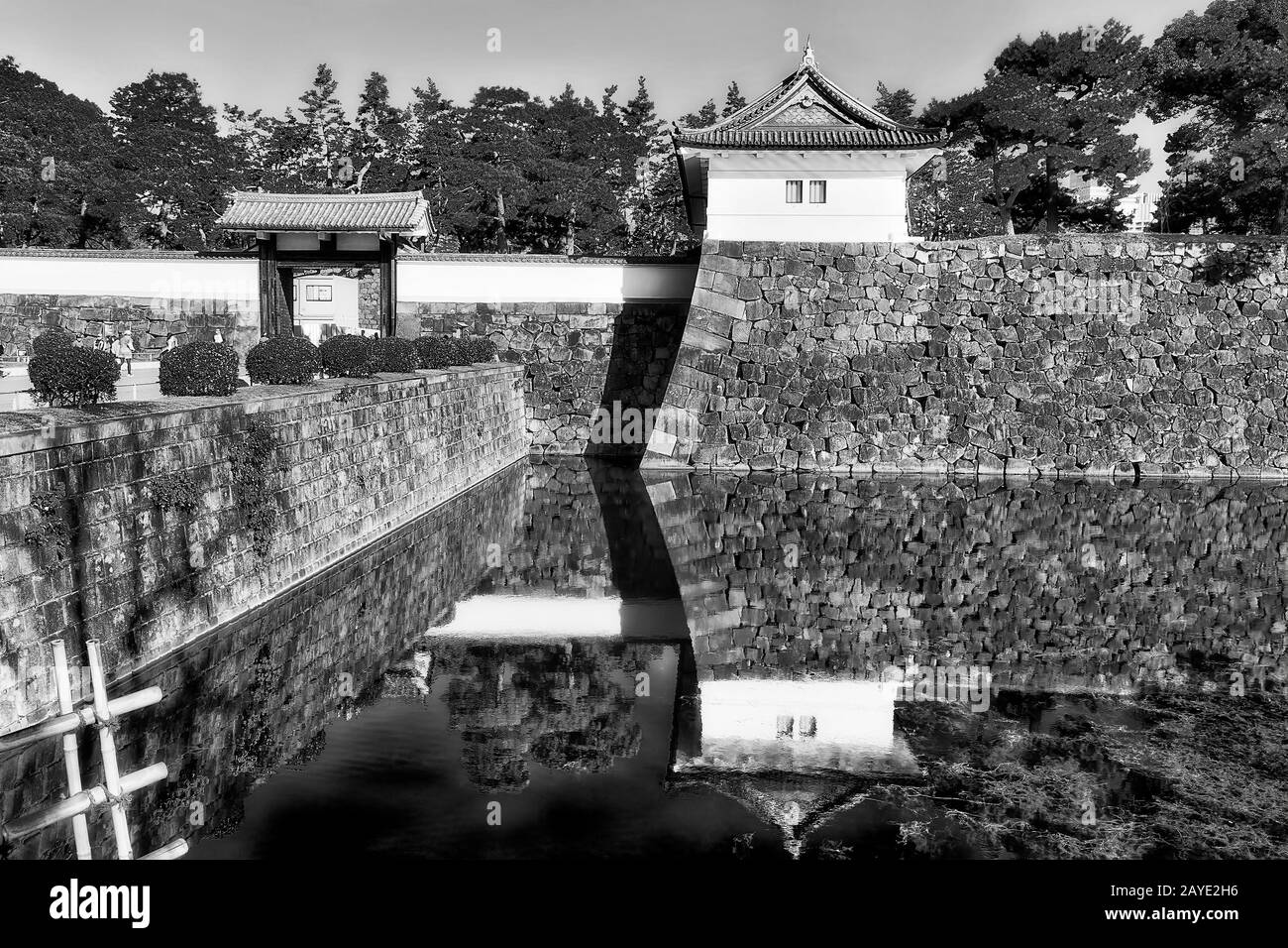 Immagine bianca nera ad alto contrasto di forti pareti in pietra e ampio fossato d'acqua intorno al castello imperiale di edo e al parco nella città giapponese di Tokyo. Foto Stock