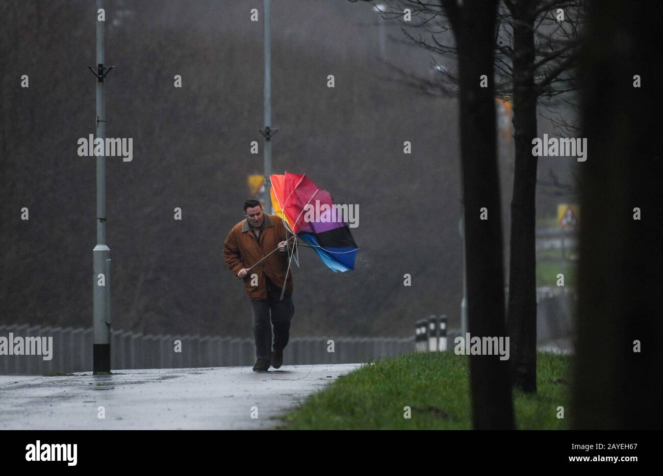 Gower, Swansea, Regno Unito. 15th febbraio 2020. UK Weather: Un uomo lotta con un ombrello su un marciapiede come Storm Dennis porta maltempo a Swansea nel Galles del Sud, come il Regno Unito è colpito da venti 70mph e pioggia pesante come un altro chiamato tempesta interrompe il fine settimana. Credito : Robert Melen/Alamy Live News. Foto Stock