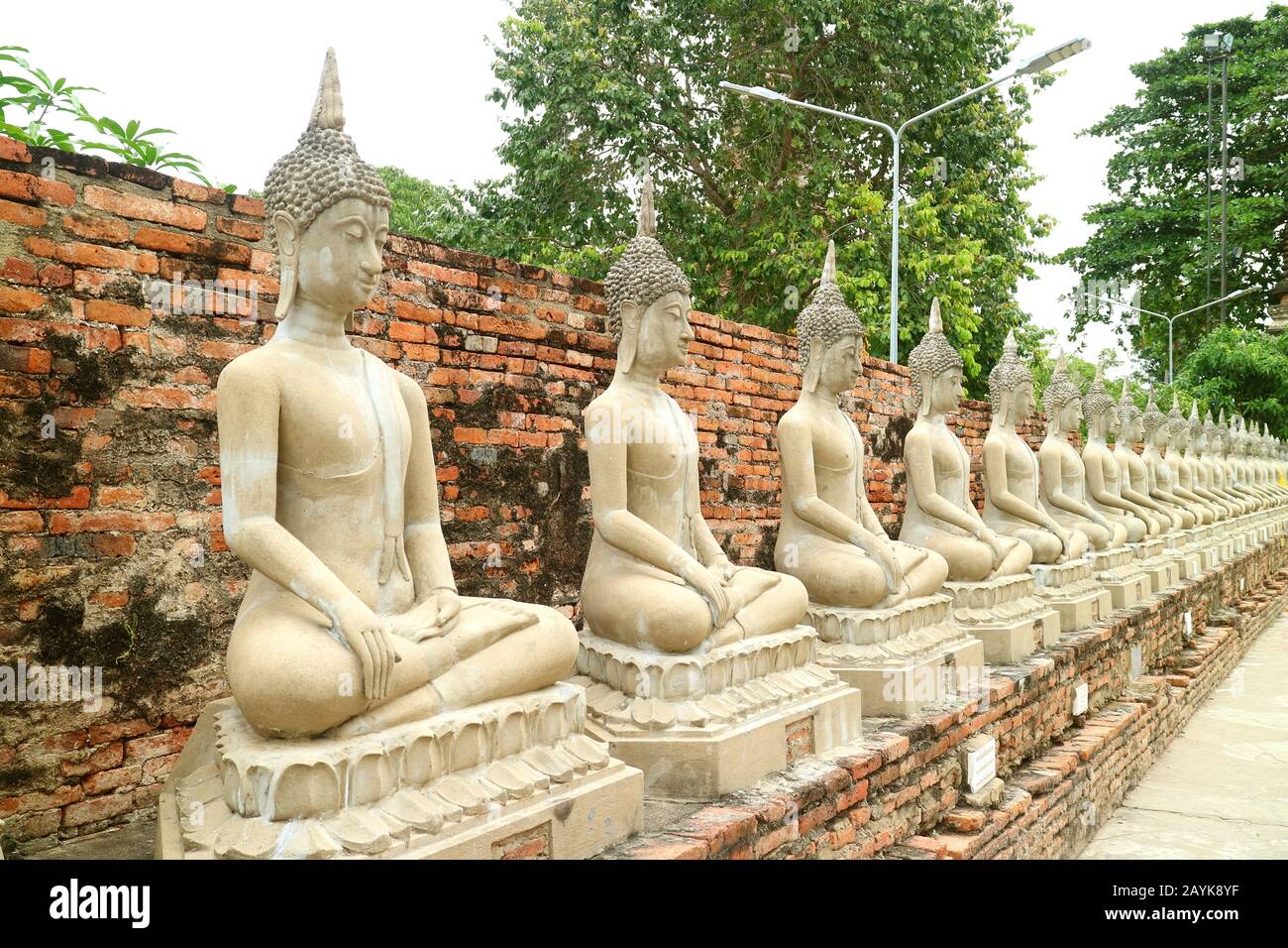 Row Of The Buddha Images In Circa La Parete Interna Del Tempio Antico Wat Yai Chai Mongkhon, Il Parco Storico Di Ayutthaya, Thailandia Foto Stock