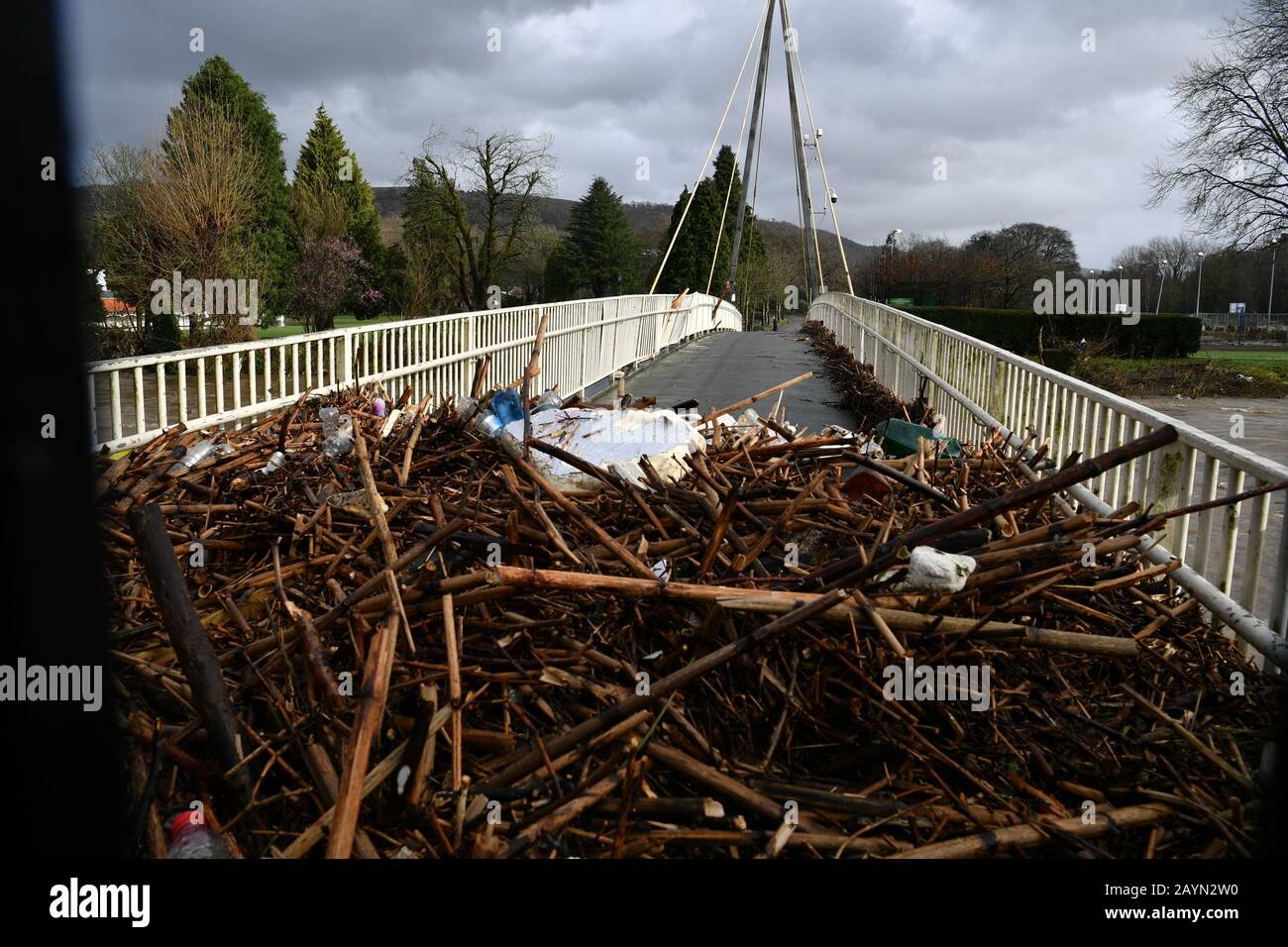 Un ponte pedonale a Pontypridd è bloccato da detriti dopo che Storm Dennis ha colpito il Regno Unito. Foto Stock