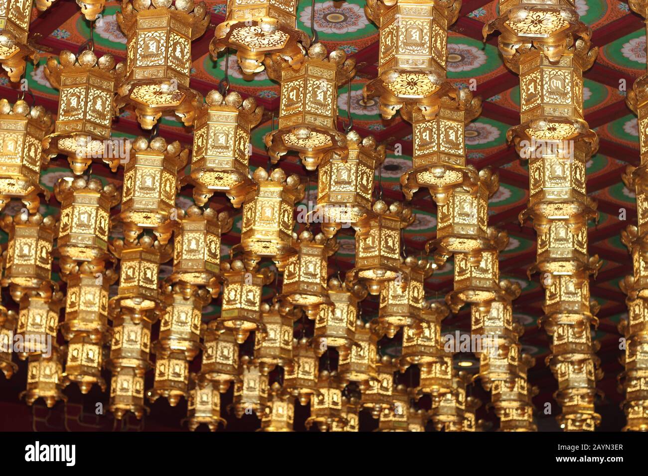 Lanterne dorate che fiancheggiano il soffitto del Tempio della Reliquia Dei Denti del Buddha a Singapore Foto Stock