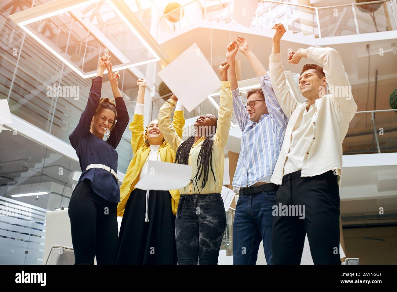 il vivace team aziendale celebra la vittoria aziendale insieme in ufficio, il felice gruppo di professionisti gioiosi gioisce per la vittoria Foto Stock
