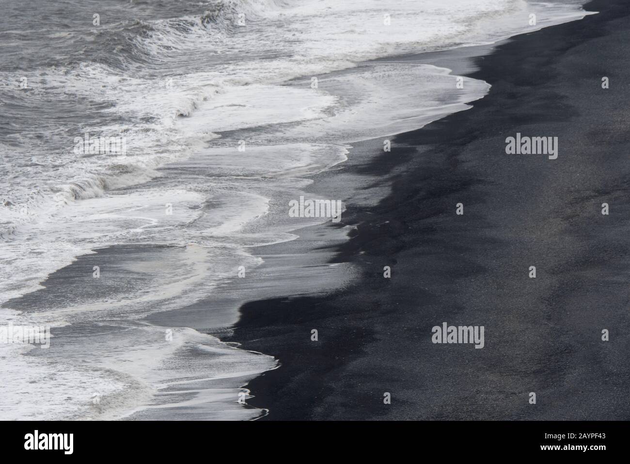 Vista verso ovest di una spiaggia nera di lava con surf che si rompe dalla cima di Dyrholaey, una piccola penisola, o promontorio, si trova sulla costa sud di Icel Foto Stock