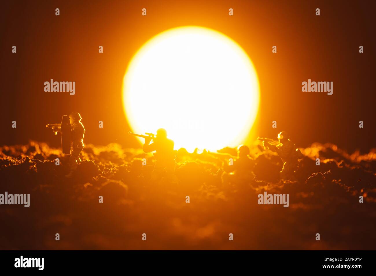 Battaglia scena di soldati giocattolo con arma e tramonto sullo sfondo Foto Stock